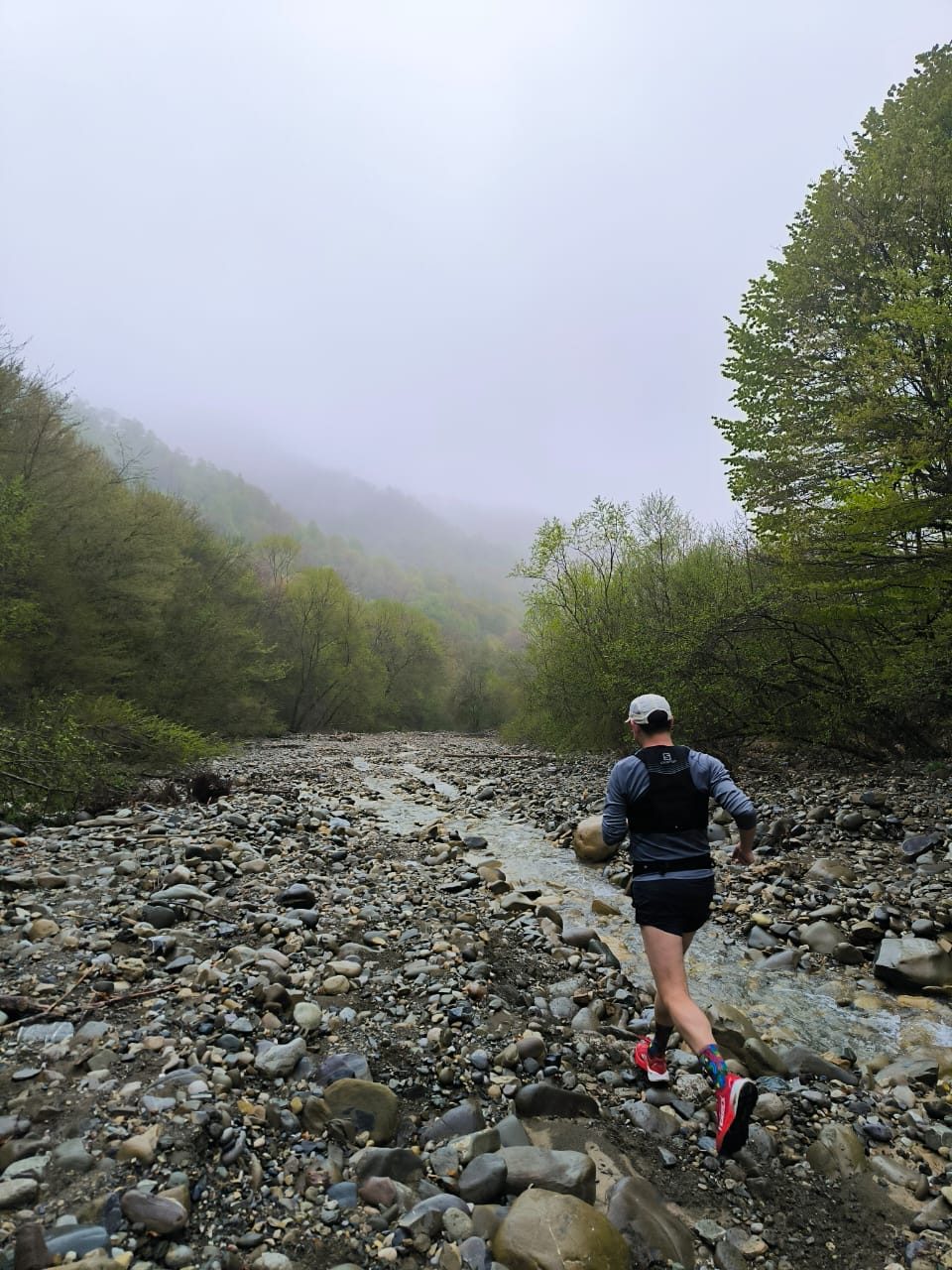 Trail running through a misty river crossing